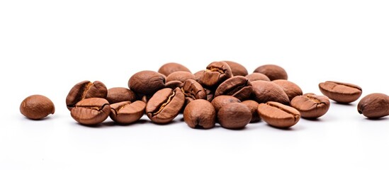 Scattered coffee beans on a clean white background - aromatic drink ingredient concept
