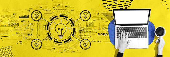 Idea light bulb theme with person using a laptop computer