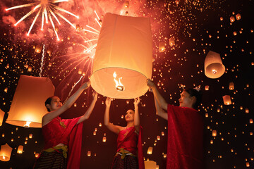 Thai people release sky floating lanterns or lamp to worship Buddha's relics with reflection. Traditional festival in Chiang mai, Thailand. Loy krathong and Yi Peng Lanna ceremony. Celebration. - 760228797