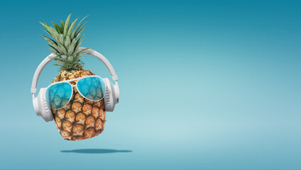 Summer minimalist pop art photography made with pineapple wearing headphones and listening to music.Minimal concept summer and party.Celebrating the summer vibes.Creative art.Contemporary style.