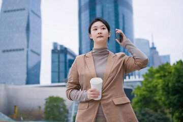 Confident Businesswoman Enjoying Coffee in the City
