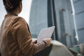 Professional Woman Using Tablet in Urban Setting