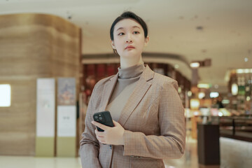 Confident Female Professional Holding Smartphone