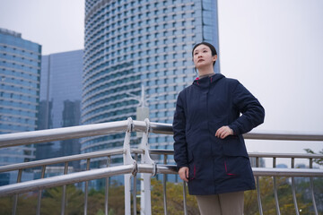 Confident Woman Standing Tall in Urban Setting