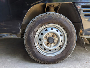 a rim and tire on the front of the car.