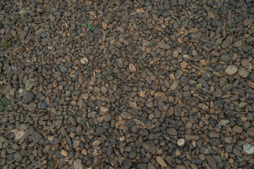 Granite gravel stone rocks flooring pattern surface texture. Close-up of exterior material for design decoration background. Rubble