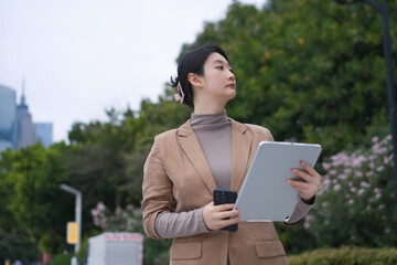 Confident Professional Using Tablet in Urban Park