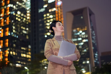 Confident Businesswoman Holding Clipboard at Night
