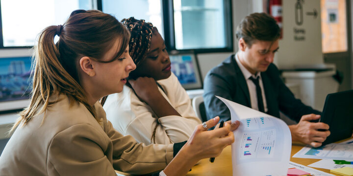 business team meeting with stats and review graphs of company target, goals or market research with data analysis. Above, table or paperwork report of growth, progress or startup performance analytics