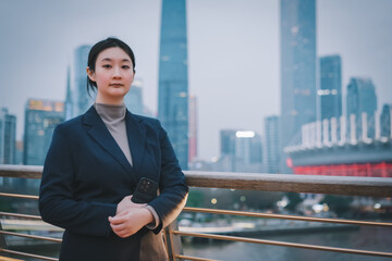Confident Businesswoman Against City Skyline at Dusk