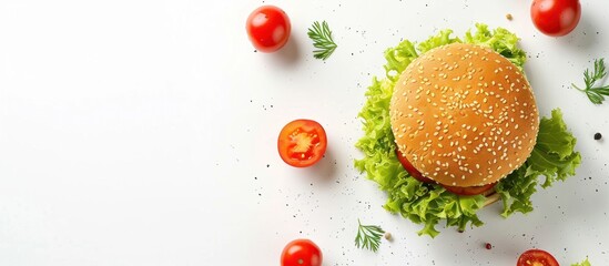 Top view of delicious burger with tomatoes, cheese slices and lettuce on white background.