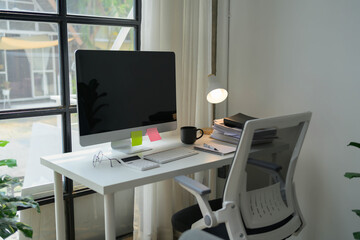 A white desk with a computer monitor, keyboard, and mouse