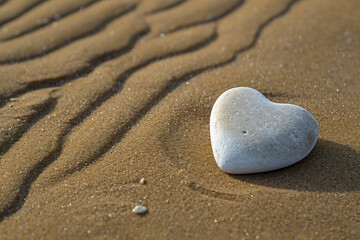 Fototapeta na wymiar a heart shaped rock on a sandy beach