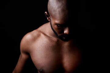 Fototapeta na wymiar Black man, muscle and fitness with shadow for workout or exercise on a dark studio background. Closeup of young African male person or bodybuilder with masculine or muscular body on mockup space