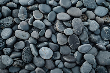a pile of black rocks with a white dot - Powered by Adobe