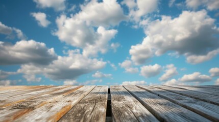 Weathered wooden planks beneath a sky painted with fluffy clouds,  offering a rustic yet serene...