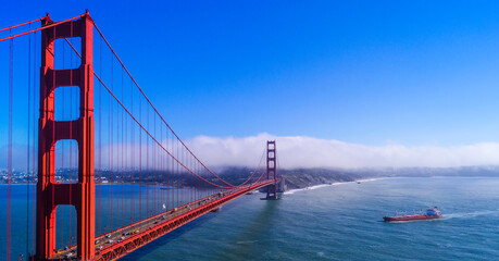 A containers ship approaches the Golden Gate Bridge in San Francisco California