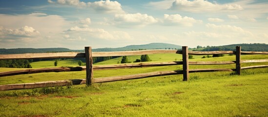 Serene Rural Scene with Wooden Fence Enclosing Lush Green Field Under Clear Blue Sky - Powered by Adobe