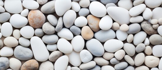 Serenity by the Shore: Tranquil White and Grey Pebbles on Sandy Beach