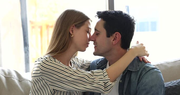 Beautiful young Hispanic couple in love kissing, depicts tender moment of affection and connection, having deeply emotional bond. Intimacy, passion between romantic partners, relationships, close up