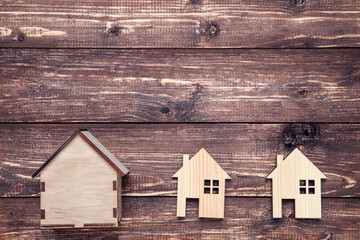 Wooden house models on brown wooden background - 760327139