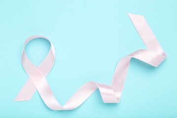 Cancer concept. Pink ribbon on blue background - 760327500