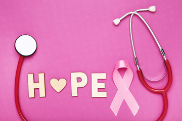 Ribbon and inscription Hope and stethoscope on pink background - 760327576