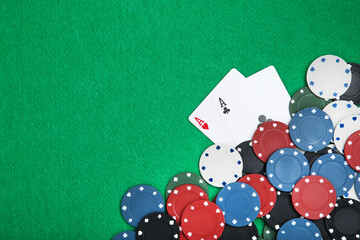 Poker chips and cards on green table - 760328161
