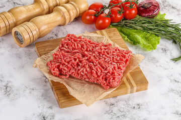 Raw minced beef meat on cutting board