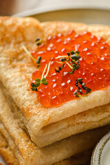 crepes with red caviar and sour cream