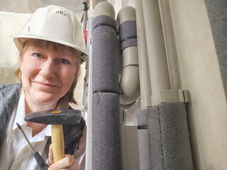 Female middle aged Technician Adjusting Industrial Water Filtration System. A woman services a...