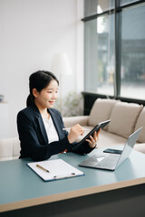 Businesswoman Analyzing Finance on Tablet and Laptop at modern Office Desk tax, report, accounting, statistics, and analytical research concept