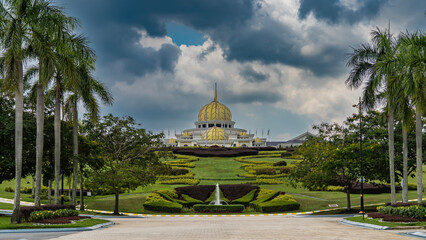 The beautiful presidential palace Istana Negara. A white building with golden domes and spires...
