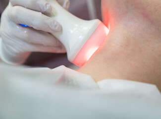 Procedure on the face. Getting photo rejuvenation at cosmetology clinic. Women in beauty salon.