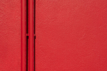 Two red pipes and red rough background .Empty space for text.