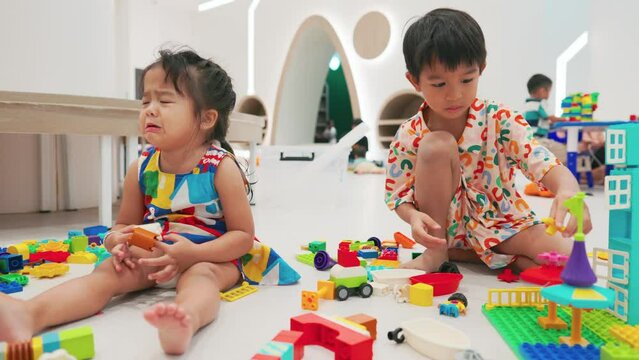 Adorable little boy and girl enjoying play toy block building imagin education learnning