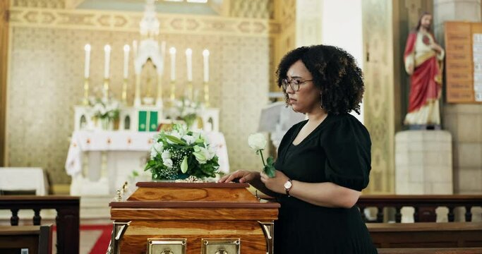Funeral, sad and woman in a church, casket and depression with ceremony or grief with religion. Person, girl or coffin with loss of a loved one or flower with death or mourning with on coffin or rose