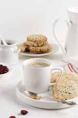 A cup of coffee with Cranberry shortbread cookies on the light table, morning breakfast, copy space