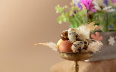 Easter composition with eggs, feathers, and spring flowers.