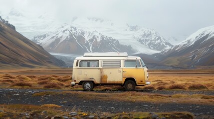 Vintage camper van parked on a desolate road with majestic mountains and a glacier in the background, evoking adventure and travel.