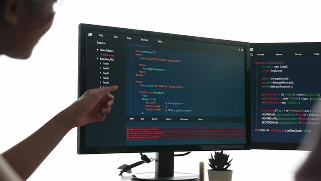 Slow motion back end software developer engineer for computer programming working together on debugging writing computing code, solving complex algorithms display on monitor in office. Burgeoning