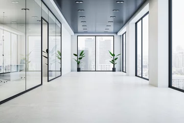 Deurstickers Modern glass office corridor interior with concrete flooring, window with city view and reflections. 3D Rendering. © Who is Danny