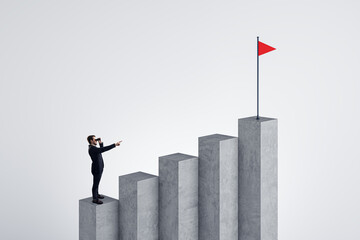 Businessman with binoculars pointing at concrete business chart top with flag on white background....