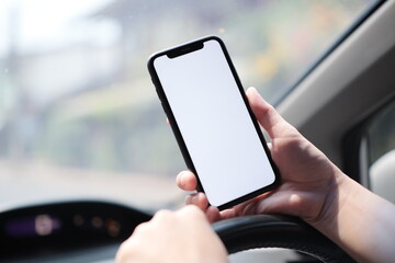 phone in hand on car