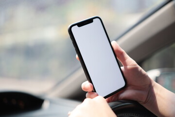 person using smartphone on car