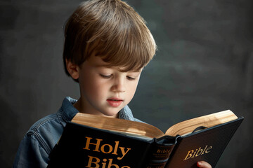 Young Boy Reading Bible, Engaged in Bible Study