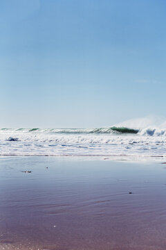 wave breaking on the seashore, high contrast, shadows