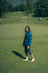 Golf course. Barefoot man on the golf course.