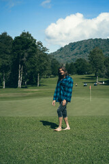 Golf course. Barefoot man on the golf course.