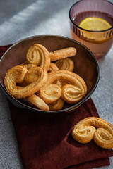 Palmiers or elephant ears, puff pastry cookies in the bowl